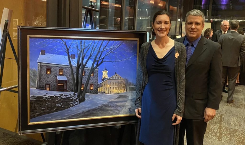 Erin and her husband Tim in front of her featured painting "Moravian Starlight"